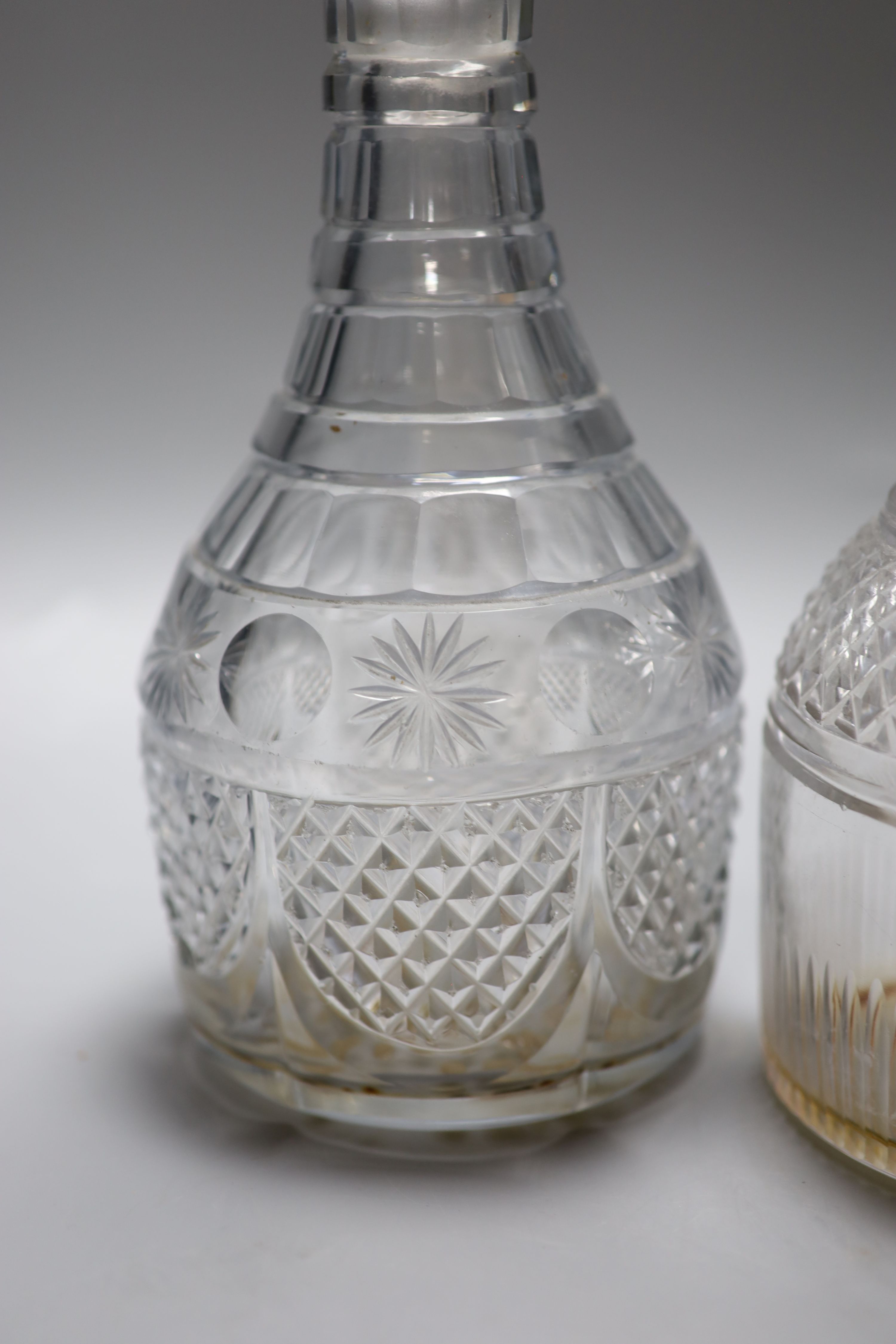 A pair of early 19th century cut glass decanters and one other